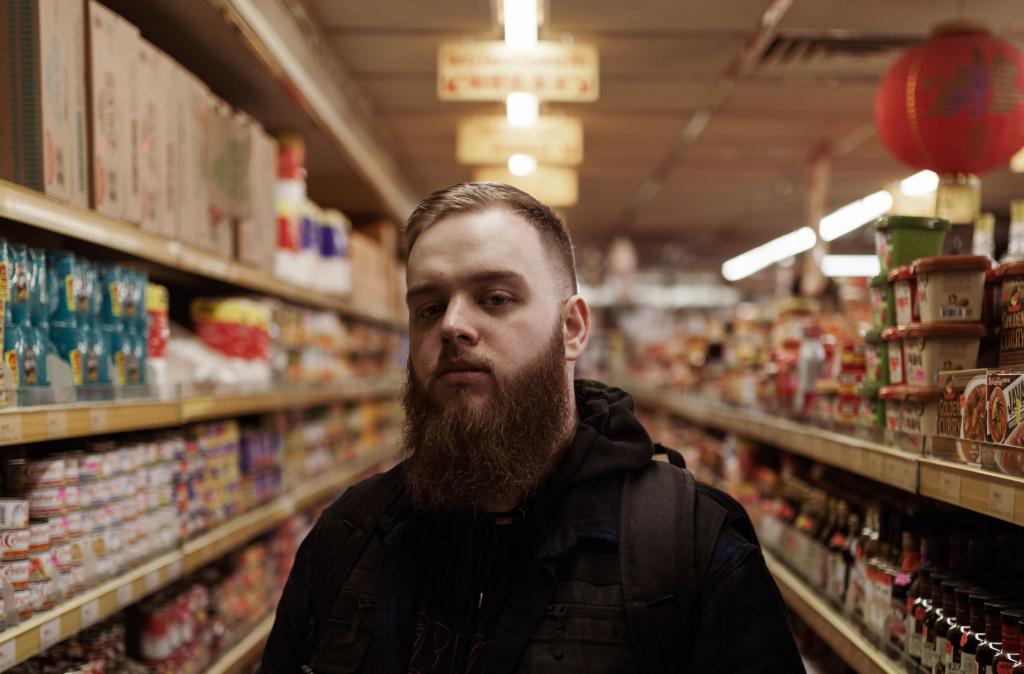 Man standing in supermarket aisle